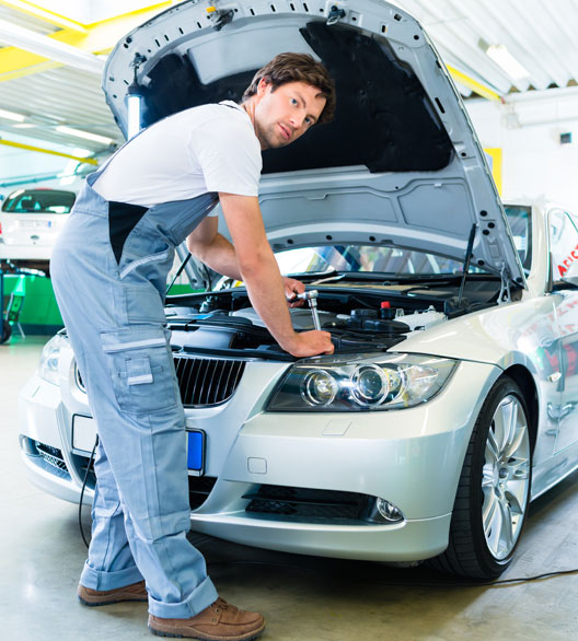 Mechanic Repairing Car at Garage