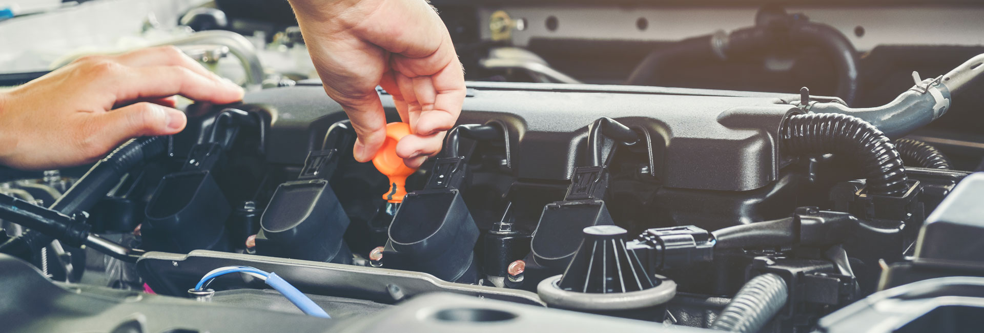 A Mechanic Checking Engine Oil